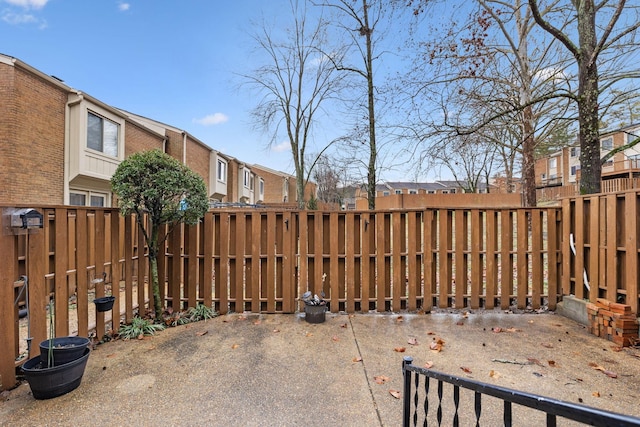 view of patio / terrace with a fenced backyard and a residential view