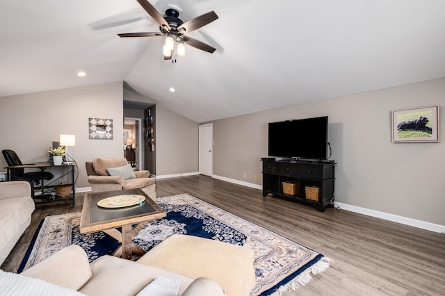 living room with vaulted ceiling, wood finished floors, and baseboards