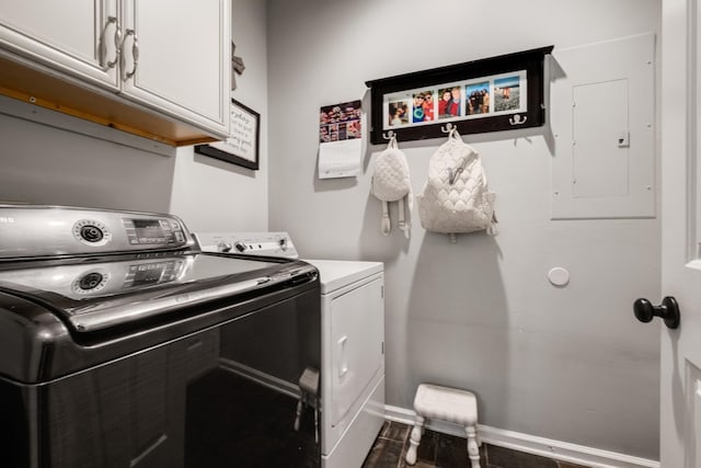 washroom featuring dark wood finished floors, washer and clothes dryer, cabinet space, electric panel, and baseboards