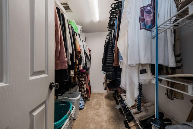 walk in closet featuring visible vents and carpet flooring