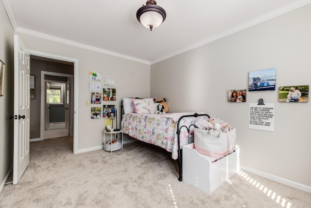 bedroom featuring carpet floors, baseboards, and crown molding