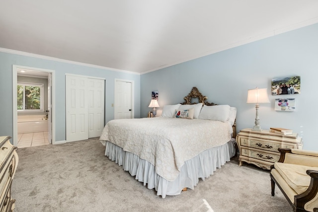 bedroom with light tile patterned flooring, light colored carpet, multiple closets, ornamental molding, and ensuite bath