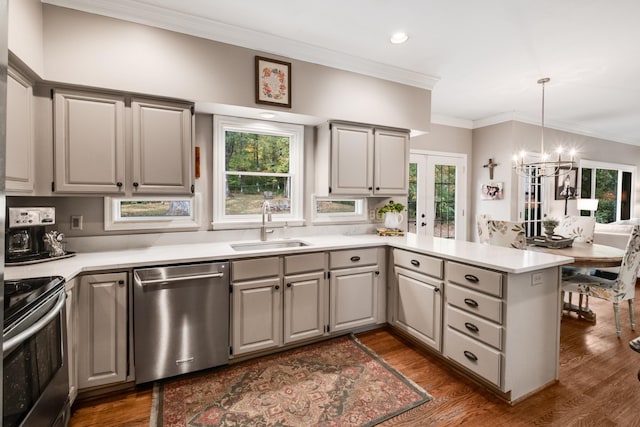 kitchen with gray cabinetry, appliances with stainless steel finishes, dark wood-type flooring, a sink, and a peninsula