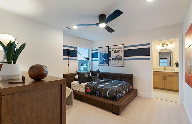 bedroom featuring baseboards, visible vents, a ceiling fan, light colored carpet, and ensuite bath