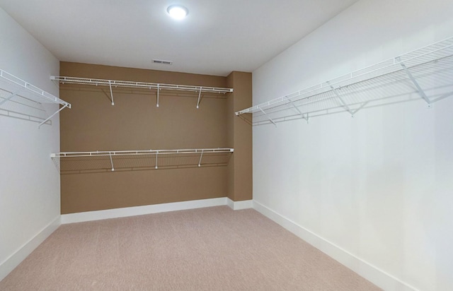 walk in closet featuring carpet and visible vents