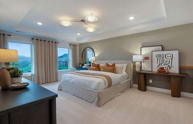 bedroom featuring light carpet, recessed lighting, a raised ceiling, and baseboards