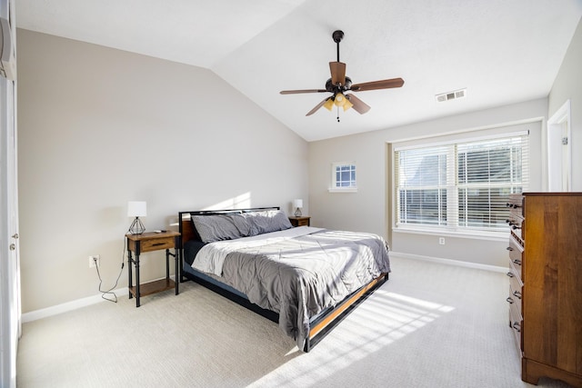 bedroom with lofted ceiling, baseboards, light carpet, and visible vents