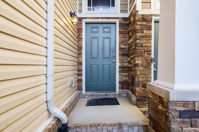 doorway to property featuring stone siding