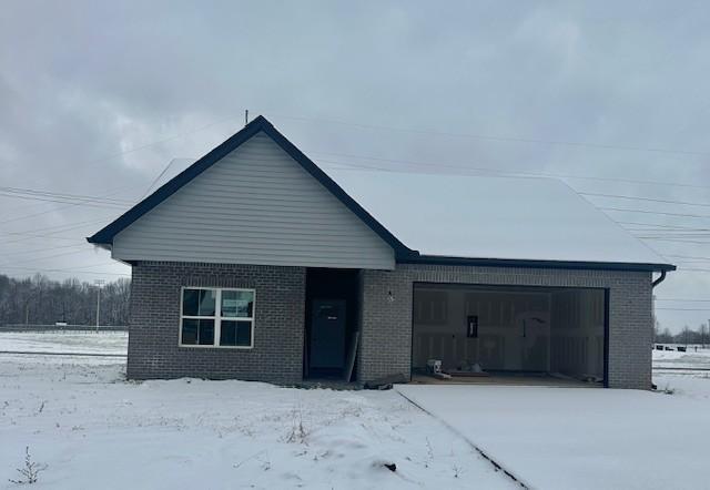 view of front facade with a garage and brick siding