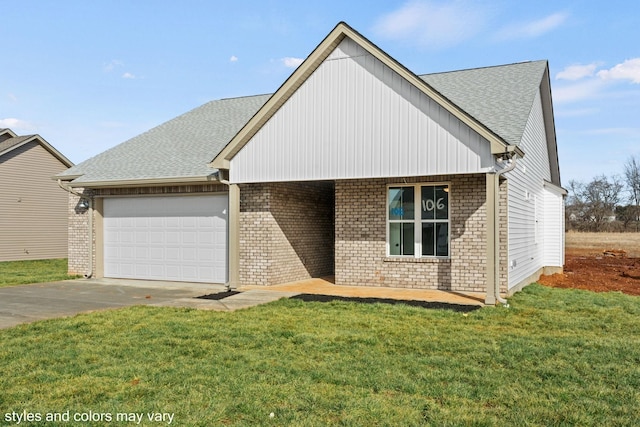 view of front of house featuring brick siding, a shingled roof, a front yard, a garage, and driveway