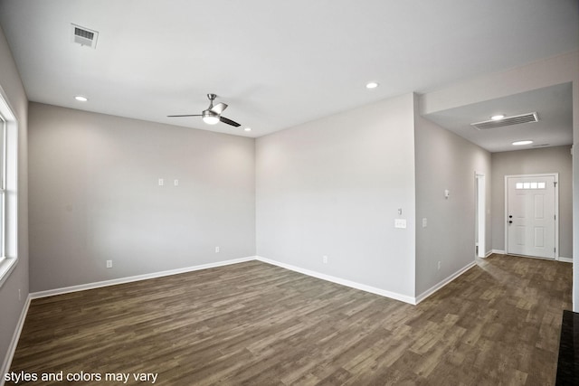 spare room featuring baseboards, visible vents, dark wood finished floors, and recessed lighting