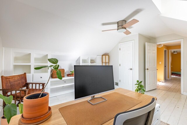 office space with vaulted ceiling, a ceiling fan, and light wood-style floors