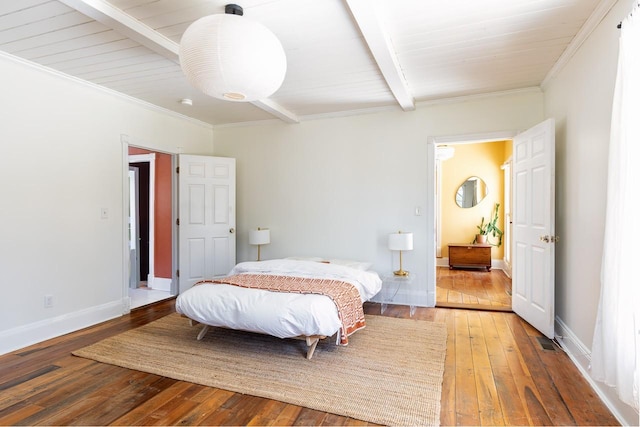 bedroom with ornamental molding, wood-type flooring, beam ceiling, and baseboards