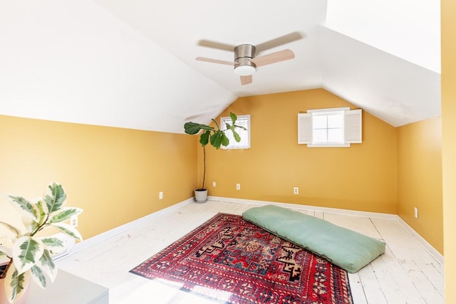 additional living space featuring a ceiling fan, vaulted ceiling, baseboards, and wood finished floors