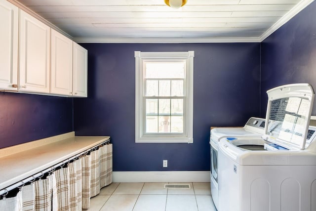 washroom with cabinet space, light tile patterned floors, visible vents, independent washer and dryer, and crown molding