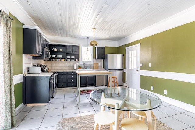 kitchen with open shelves, stainless steel appliances, light countertops, and light tile patterned flooring