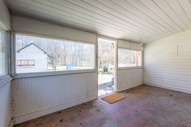 unfurnished sunroom with lofted ceiling and wood ceiling