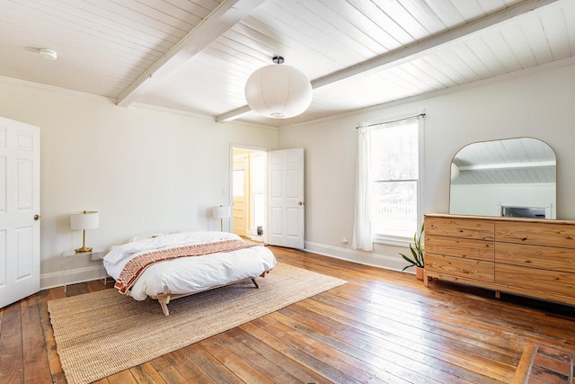 bedroom with ornamental molding, wood-type flooring, beamed ceiling, and baseboards