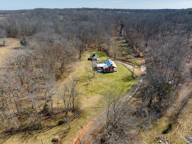 aerial view featuring a wooded view and a rural view