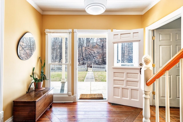 entryway featuring stairs, hardwood / wood-style flooring, and crown molding