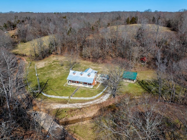 bird's eye view featuring a wooded view and a rural view