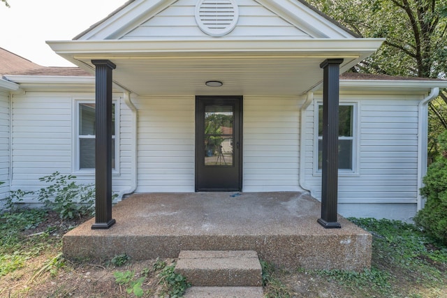 view of exterior entry featuring a porch