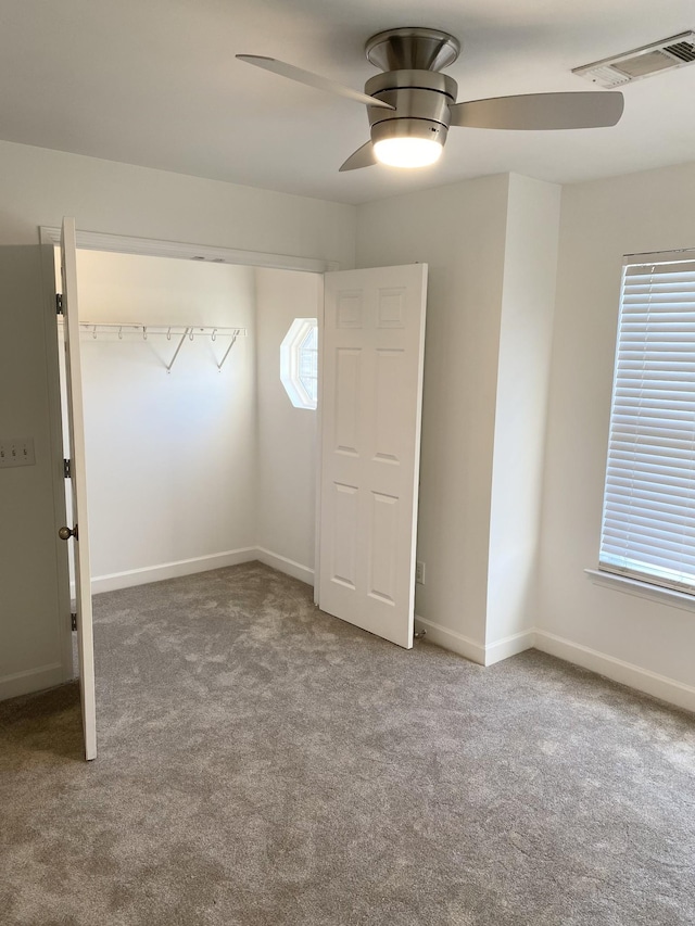 interior space featuring carpet, visible vents, ceiling fan, and baseboards