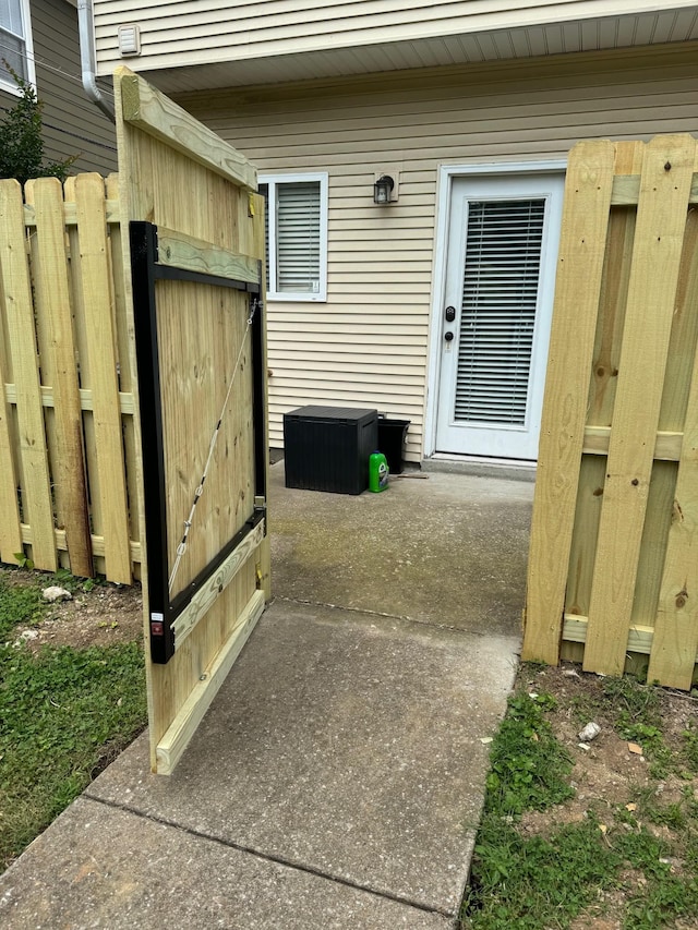 view of exterior entry featuring fence