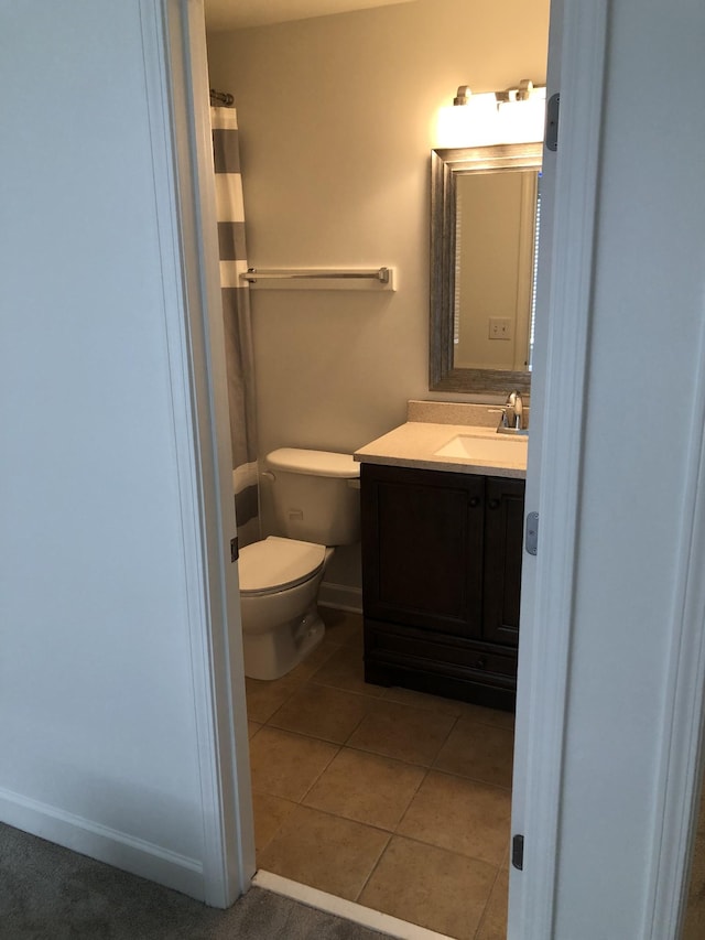 bathroom with vanity, toilet, and tile patterned floors