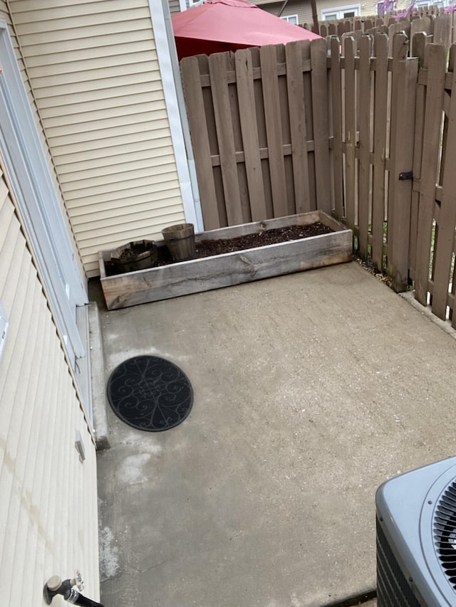 view of patio / terrace with fence and central AC unit