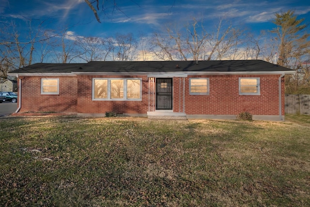 ranch-style house with brick siding and a front lawn