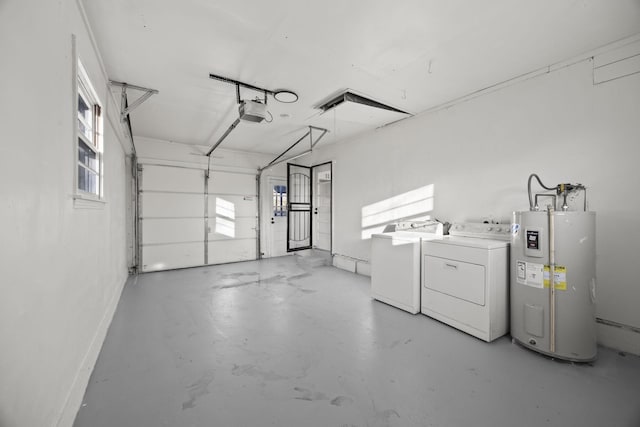 garage with a garage door opener, washing machine and dryer, electric water heater, and baseboards