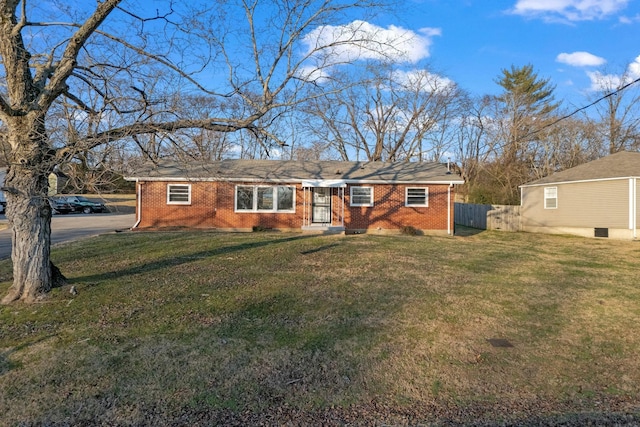 ranch-style home with brick siding, a front lawn, and fence