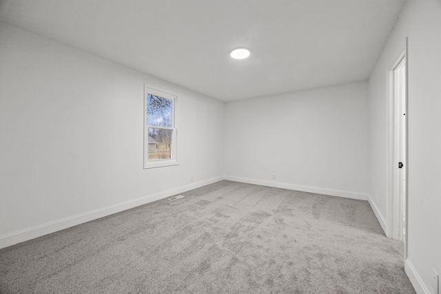 carpeted empty room with baseboards