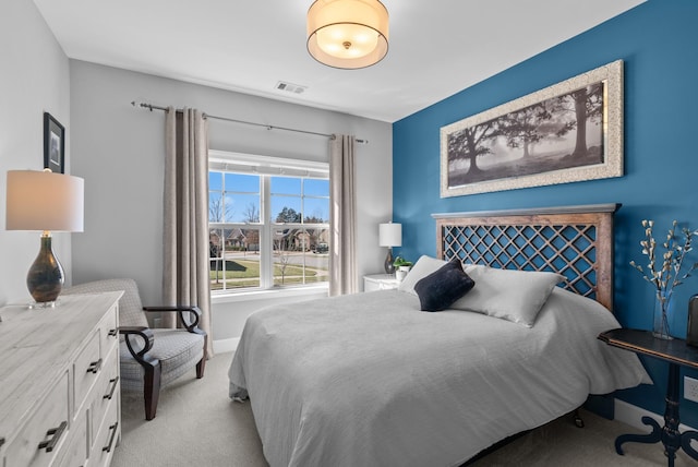 carpeted bedroom with visible vents and baseboards