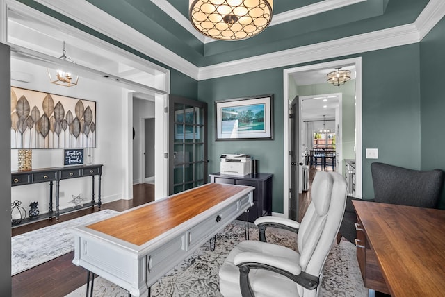 home office with a chandelier, crown molding, baseboards, and wood finished floors