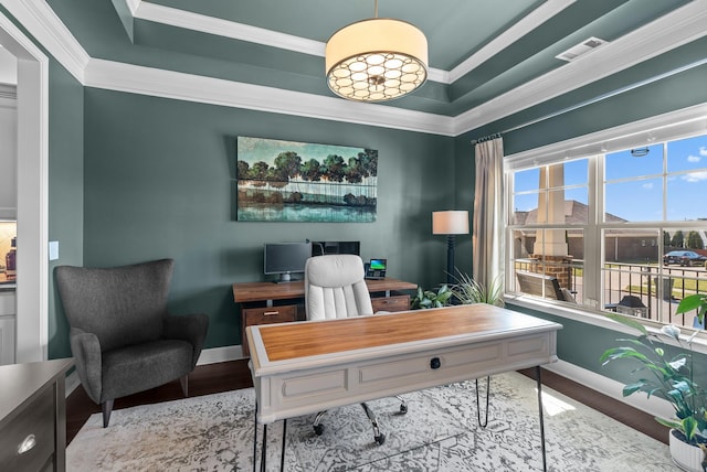 office space with a tray ceiling, crown molding, and baseboards