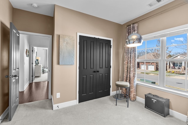 sitting room featuring baseboards, visible vents, and carpet flooring