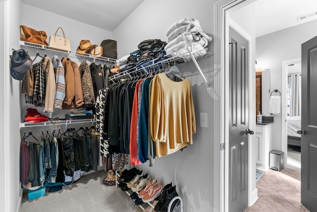 walk in closet featuring tile patterned flooring and visible vents