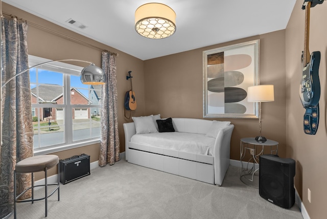 sitting room with carpet, visible vents, and baseboards