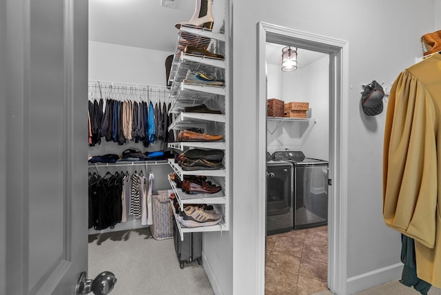 walk in closet featuring washer and clothes dryer and tile patterned floors