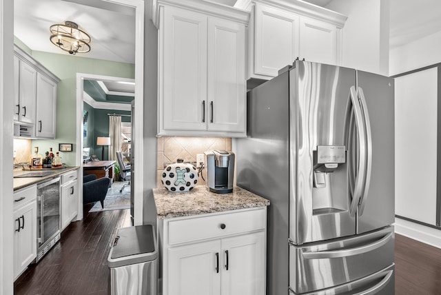 kitchen featuring stainless steel fridge, tasteful backsplash, wine cooler, dark wood-type flooring, and light stone countertops