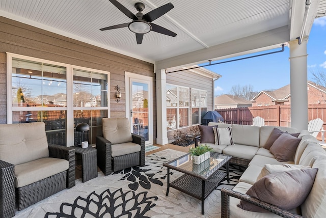 sunroom featuring a ceiling fan