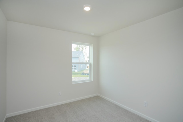 empty room with recessed lighting, baseboards, and light colored carpet