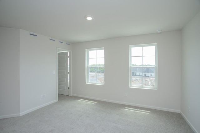 carpeted spare room with baseboards