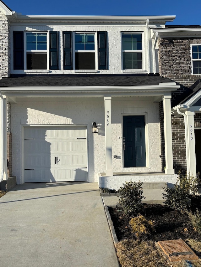 view of front of home featuring a garage, concrete driveway, and stucco siding