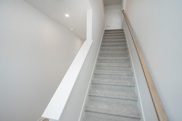 stairs with recessed lighting and carpet flooring