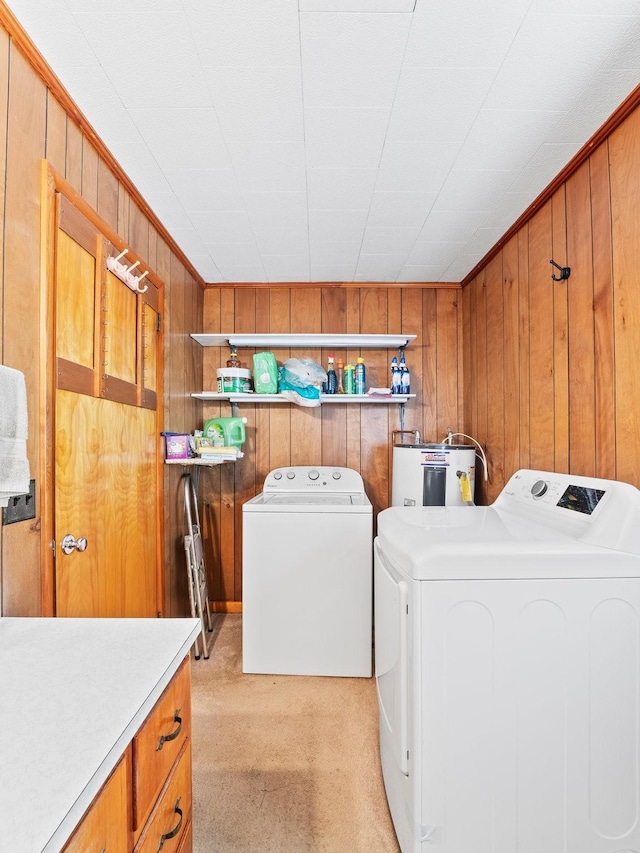 laundry room with light carpet, cabinet space, washing machine and dryer, and water heater