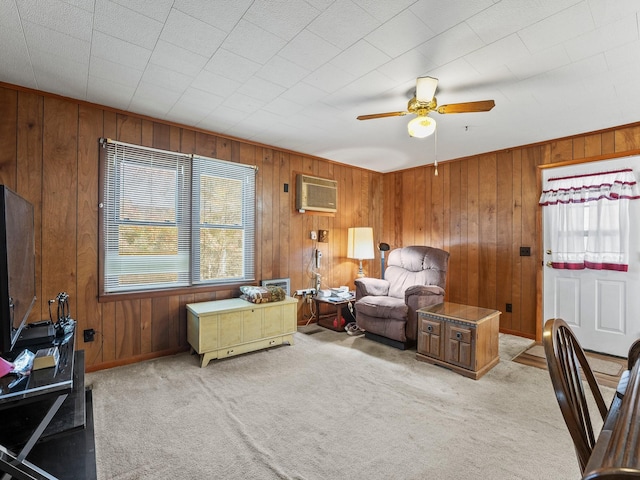 living room featuring a wall unit AC, plenty of natural light, light carpet, and ceiling fan