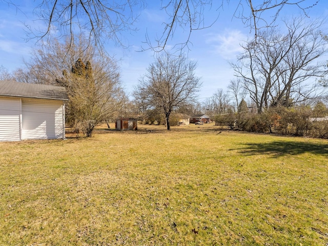 view of yard with an outbuilding and a storage shed